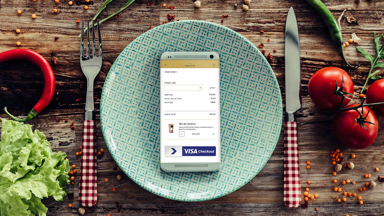 Mobile phone on top of a plate with the Visa Checkout logo visible on screen.